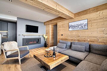 A living room with a couch a chair and a fireplace