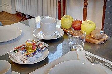 A bottle of nutella sits on a plate on a table