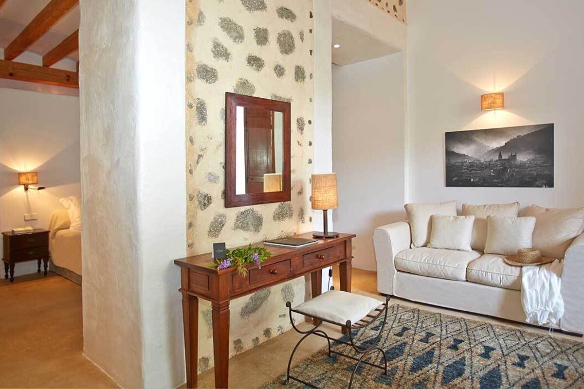 A living room with a couch and a mirror