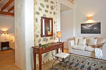 A living room with a couch and a mirror