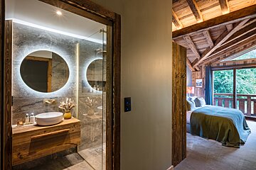 A bathroom with two round mirrors and a sink