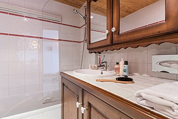 A bathroom with a sink and a bottle of gel on the counter