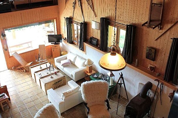An aerial view of a living room with a couch and chairs