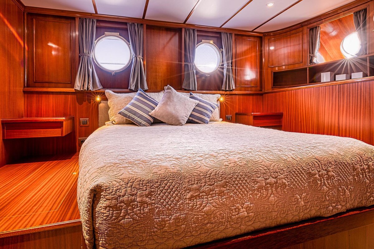 A bedroom with a large bed and two windows