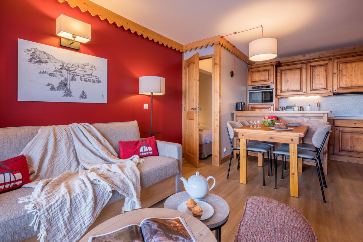 A living room with a couch and a table with a picture on the wall that says alps