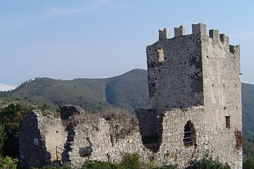 A stone tower with a mountain in the background