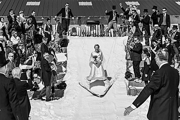 A black and white photo of a bride on skis