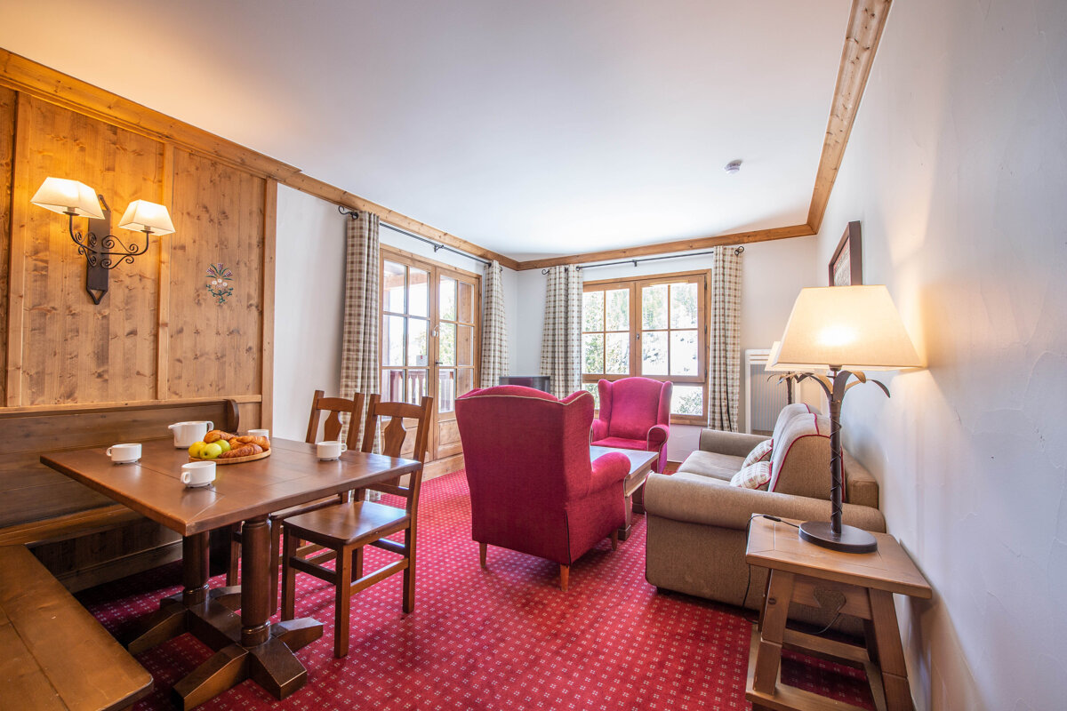 A living room with a table and chairs and a couch