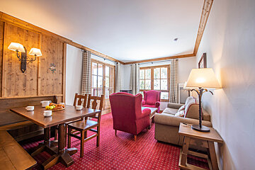 A living room with a table and chairs and a couch