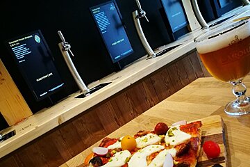 a beer and some food on a table in chamonix