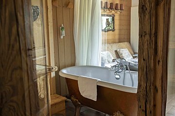 A bathroom with a bathtub and a mirror