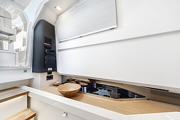 A wooden bowl sits on a counter in a kitchen
