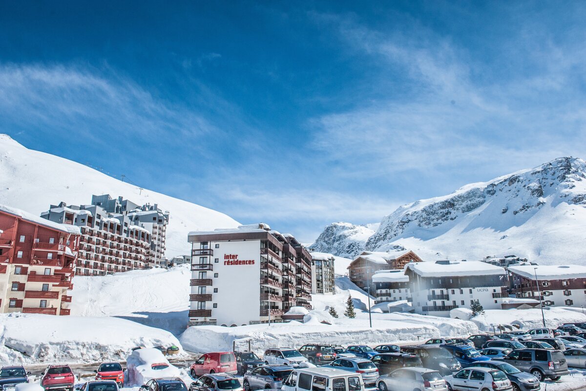 A snowy area with a building that says inter residences