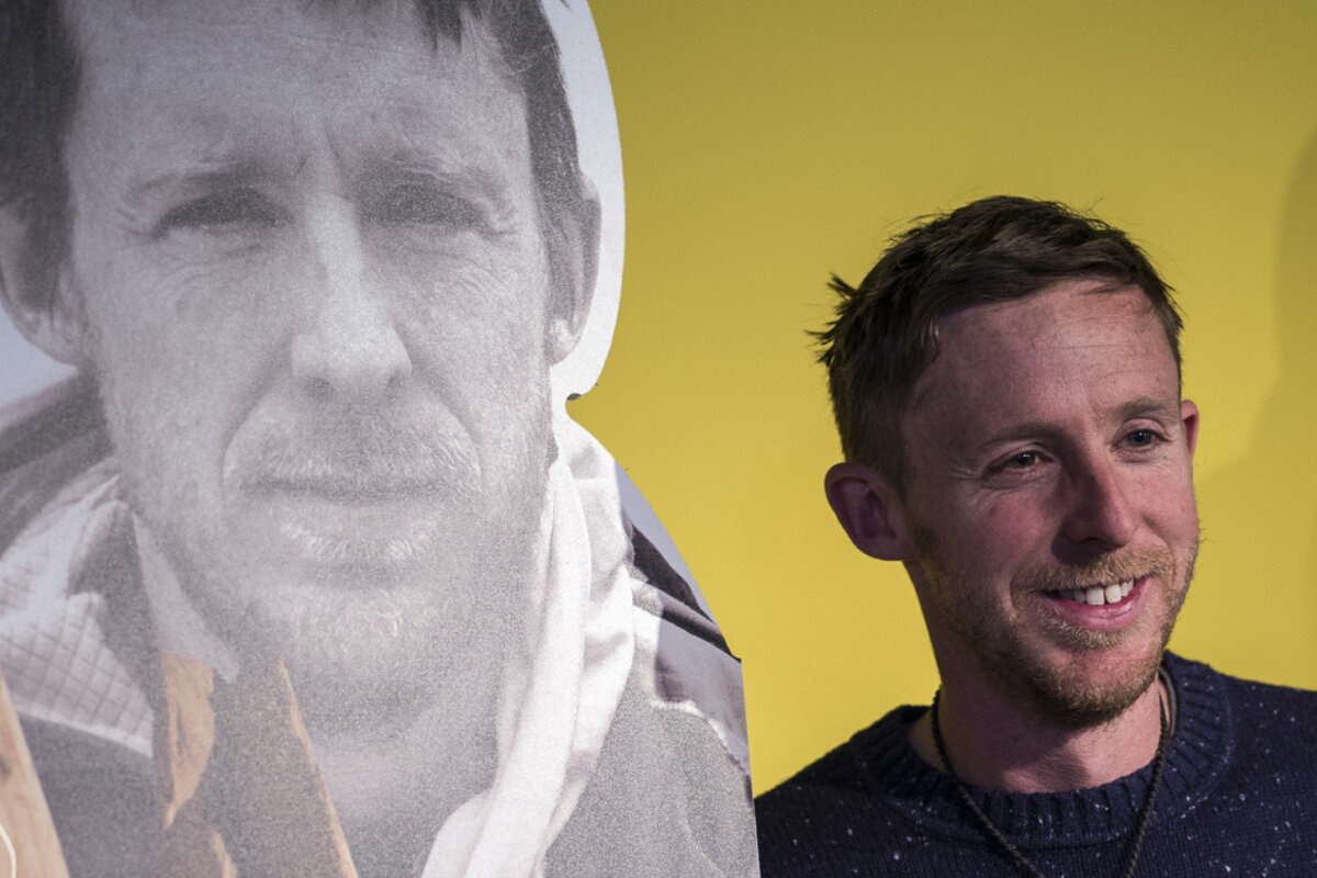 man in front of his own poster - Tommy Caldwell