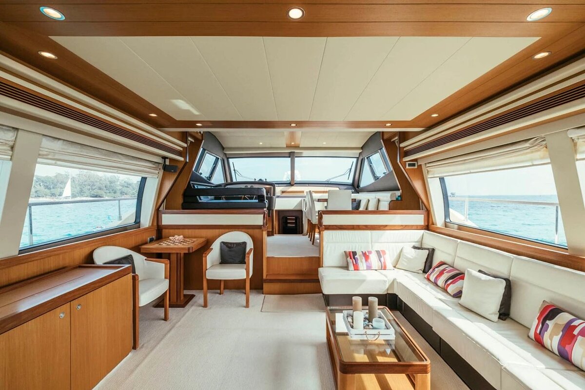 A living room on a boat with a table and chairs