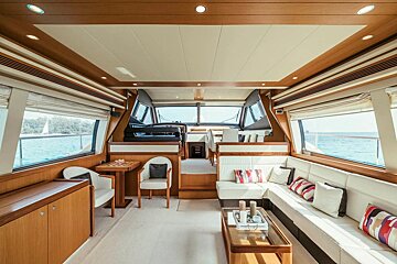 A living room on a boat with a table and chairs