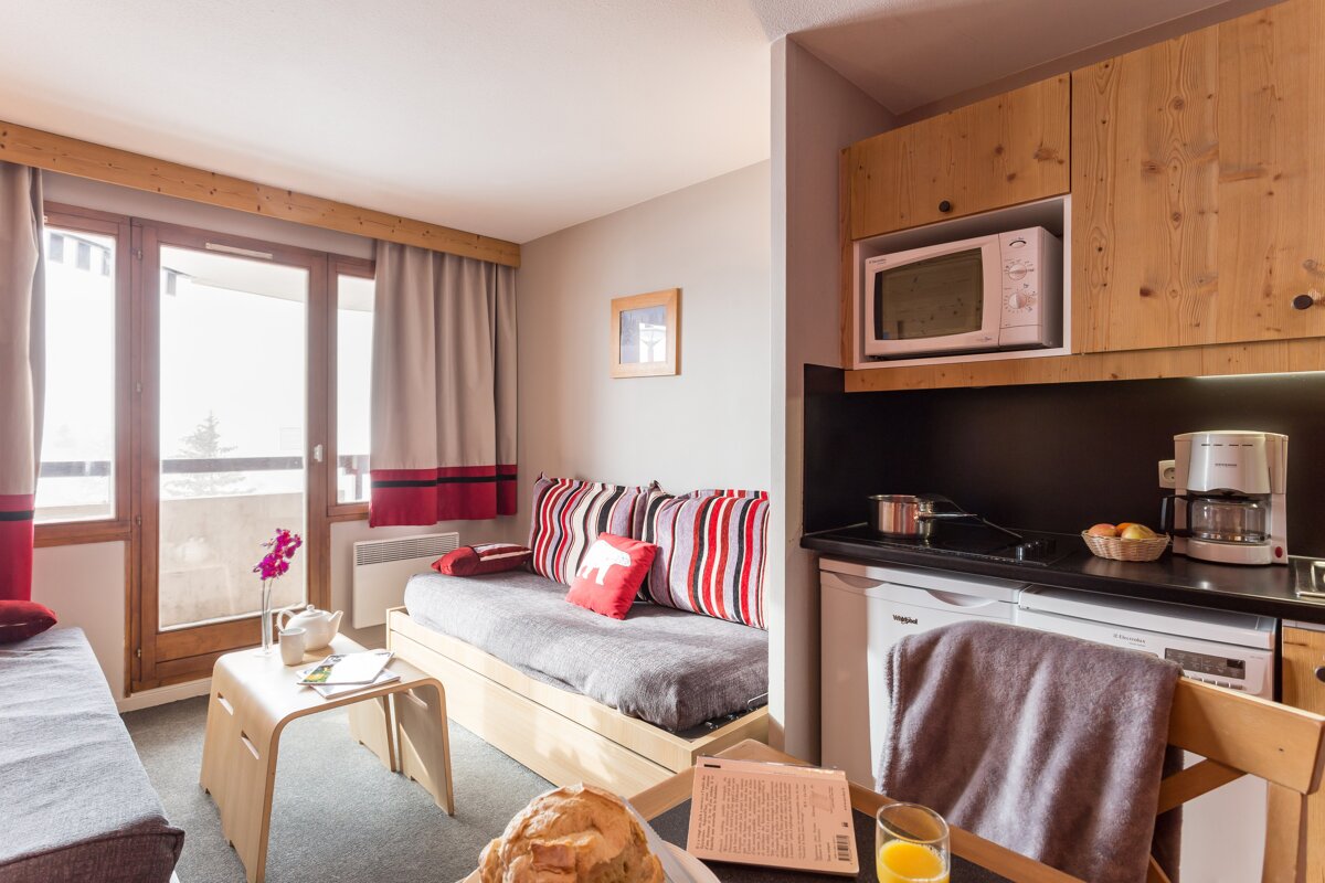 A kitchen with a microwave and a coffee maker