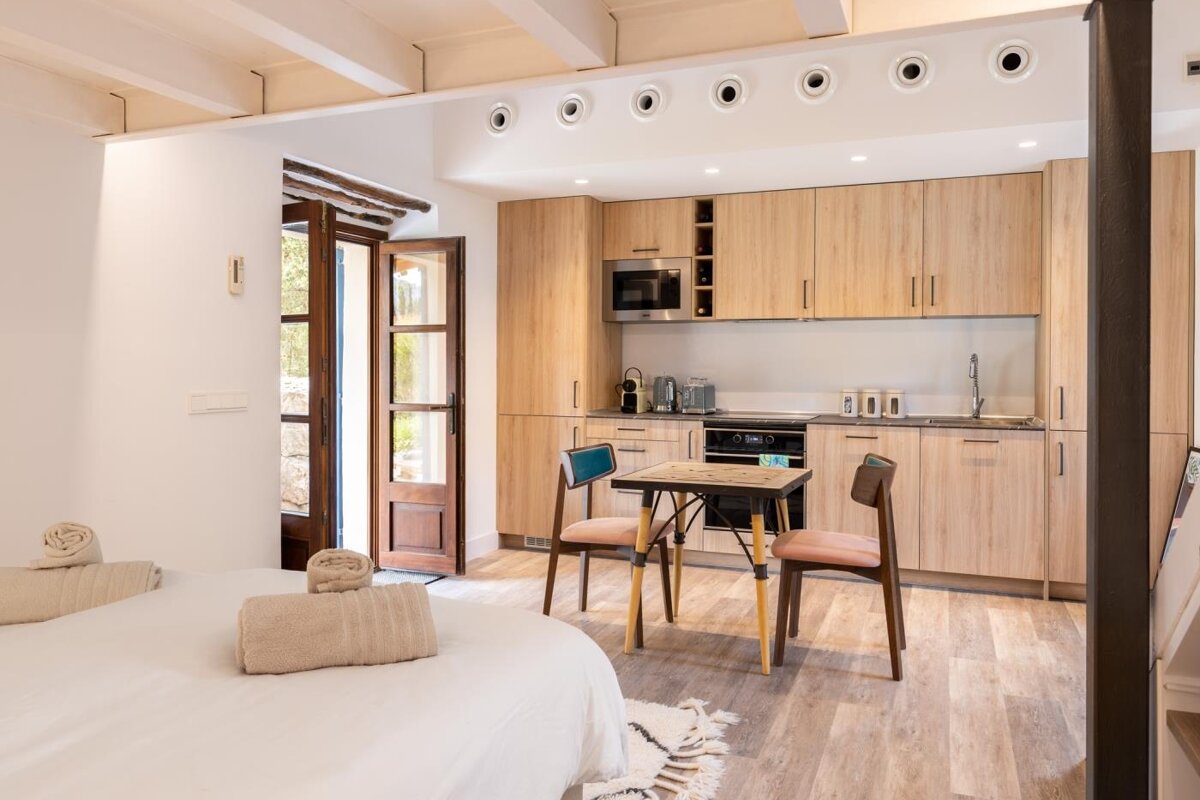 A kitchen with a table and chairs in it