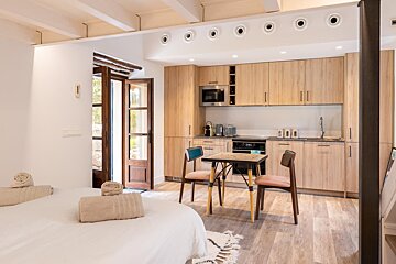 A kitchen with a table and chairs in it