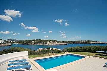A large swimming pool with a view of the ocean