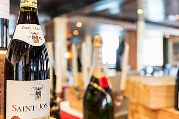A bottle of saint-josse wine sits on a shelf