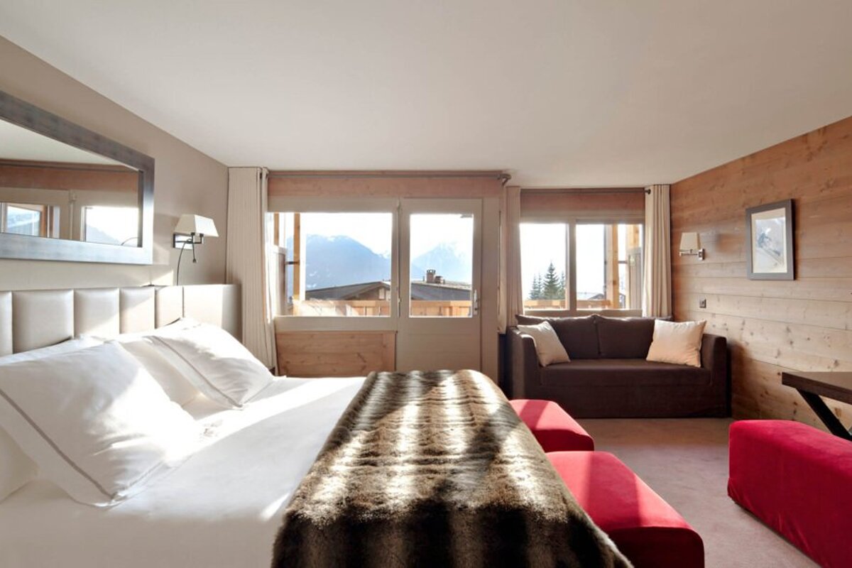 A hotel room with a bed and a couch