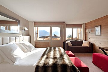 A hotel room with a bed and a couch
