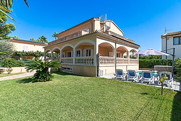 A large house with a large lawn in front of it