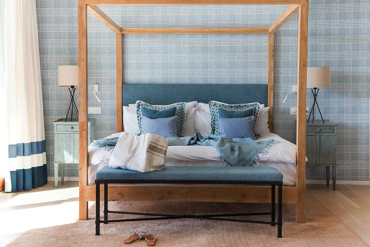 A blue and white bedroom with a canopy bed