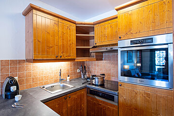 A kitchen with wooden cabinets and a whirlpool oven