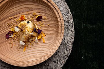 Dessert plated on a wooden dish at Alpage restaurantCourchevel