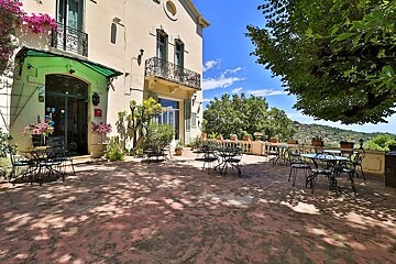 A patio with tables and chairs in front of a building