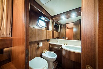 A bathroom with a toilet a sink and a mirror