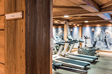 A gym with treadmills and a sign that says fitness