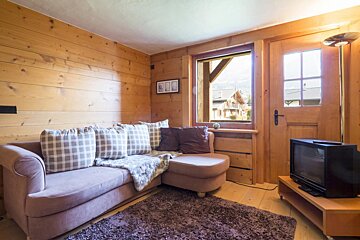 A living room with a couch and a television