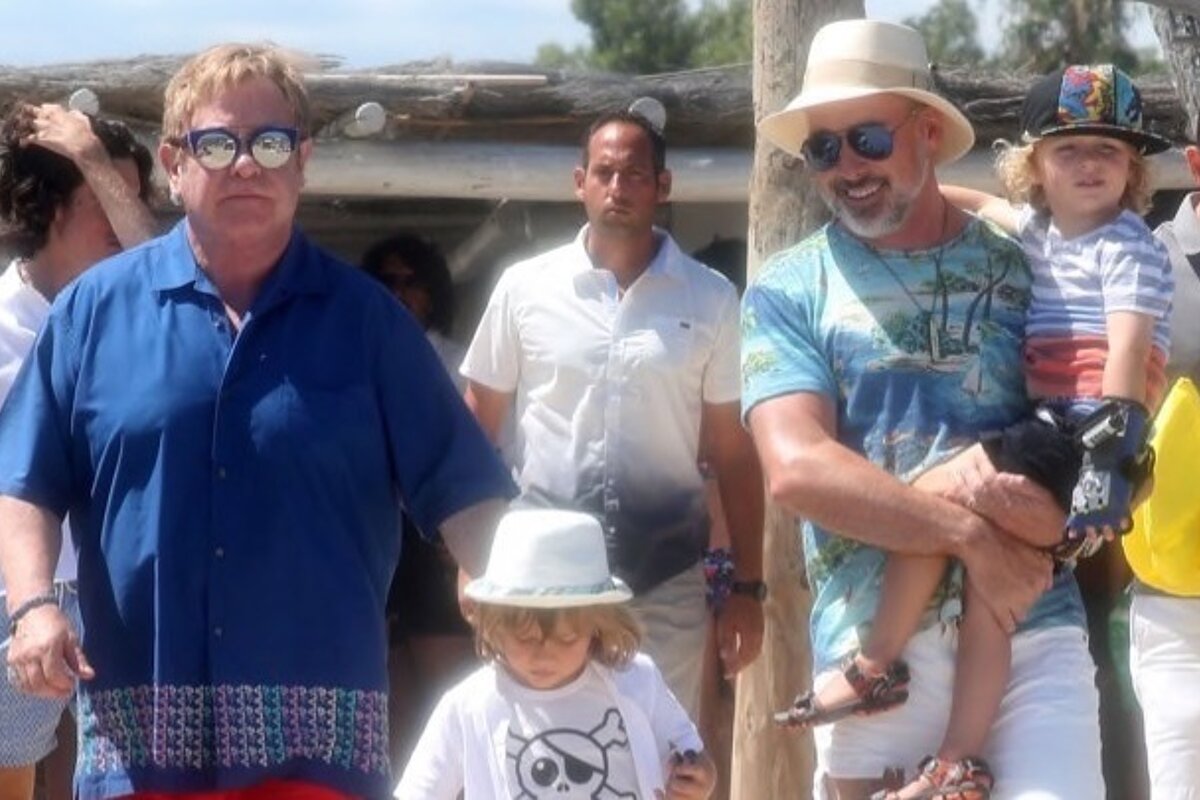 Singer Elton John, husband & children leaving a beach club in st tropez