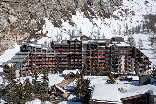 A large building in the middle of a snowy mountain