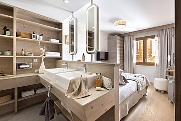 A bathroom with two sinks and two mirrors