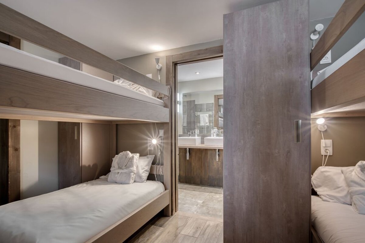 A bedroom with bunk beds and a bathroom