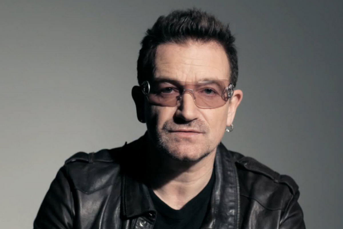 a pop star with black leather jacket and sunglasses