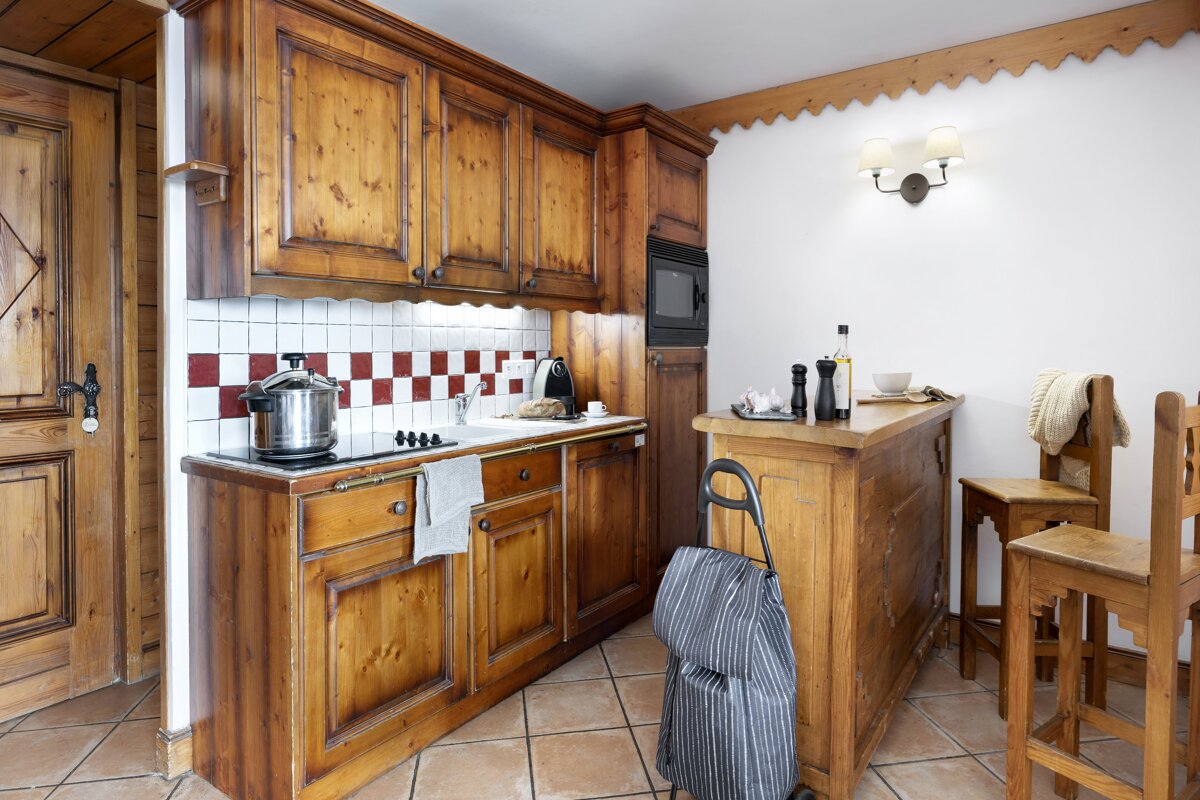 A kitchen with wooden cabinets and a stove top oven