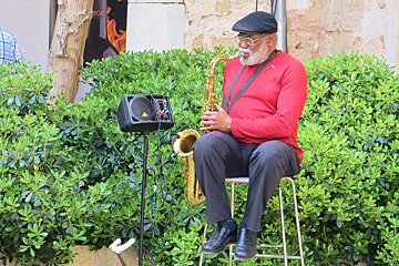 A man playing saxaphone at Pollenca wine fair