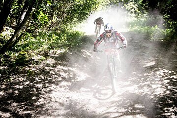 A person riding a bike with the number 88 on it