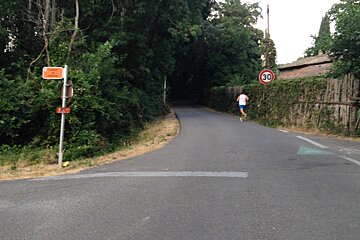 a runner and a sign post on a bike route