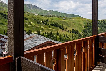 A balcony with a view of a mountain range