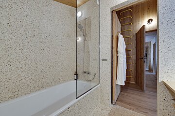 A bathroom with a bathtub and a shower