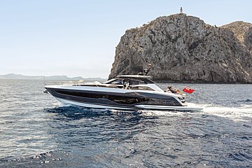 A black and white yacht is floating in the ocean