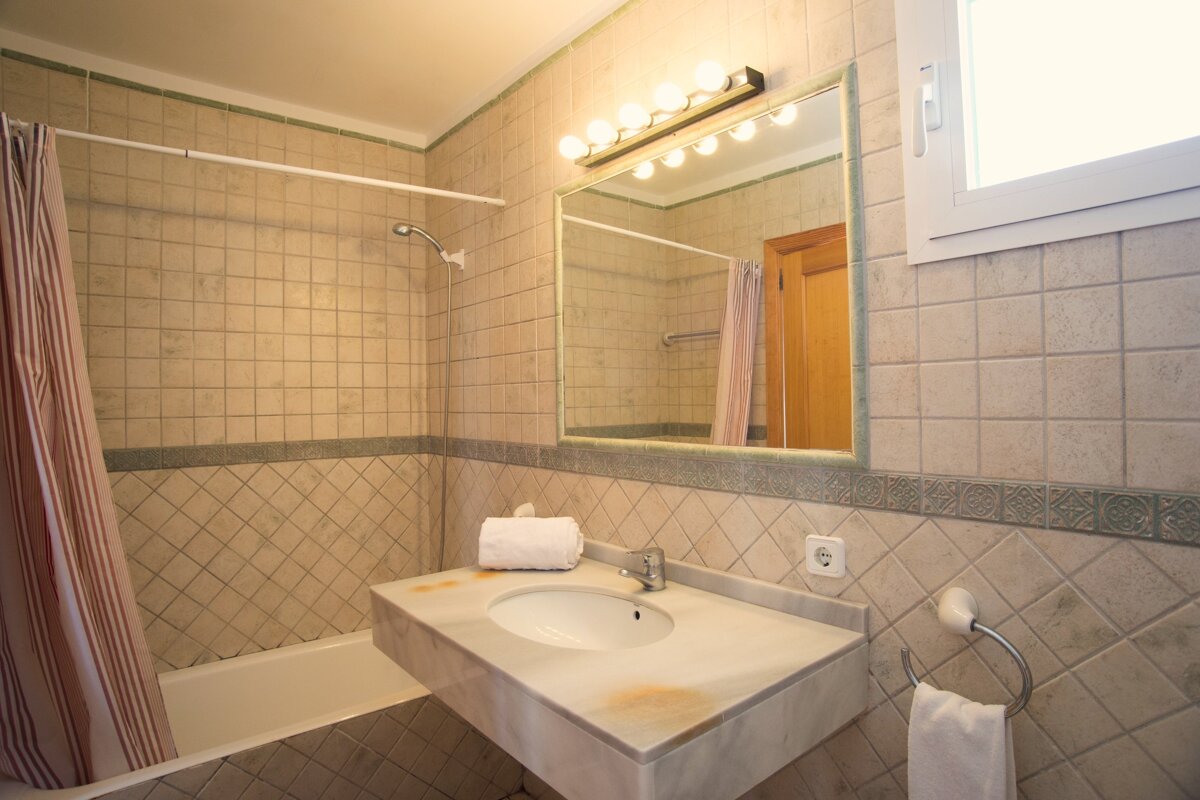 A bathroom with a sink and a large mirror