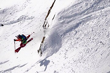 a skier jumping a cliff