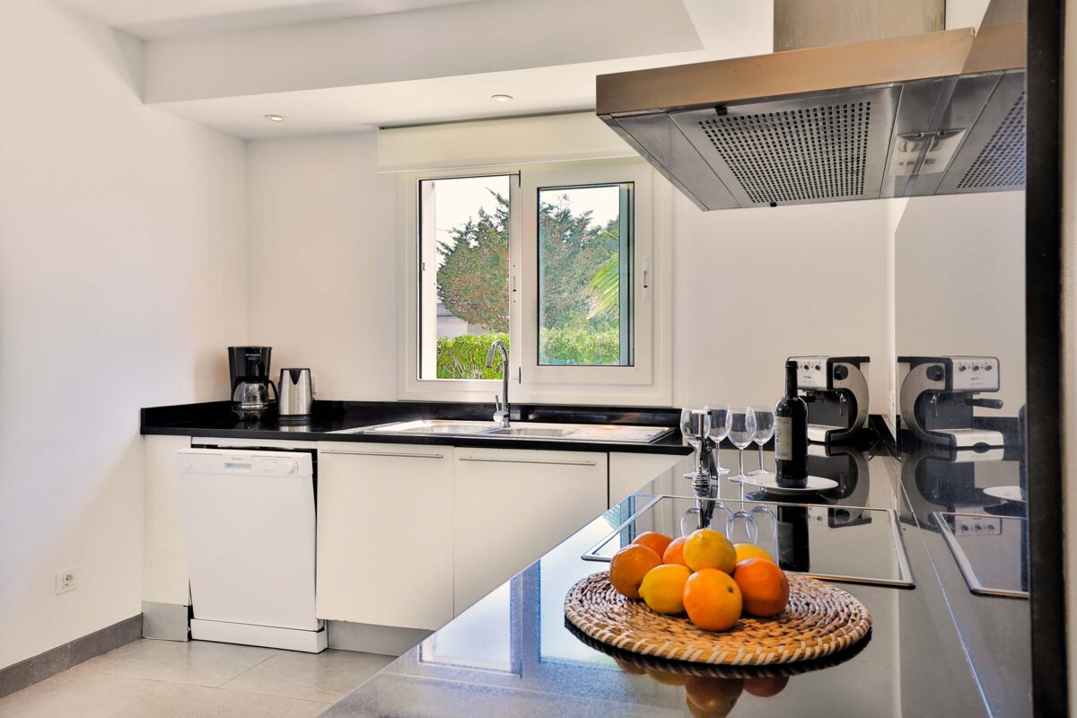 A kitchen with a bottle of wine on the counter